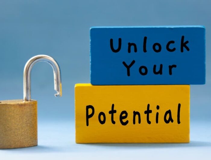 “Unlock Your Potential” text on wooden blocks next to an unlocked padlock