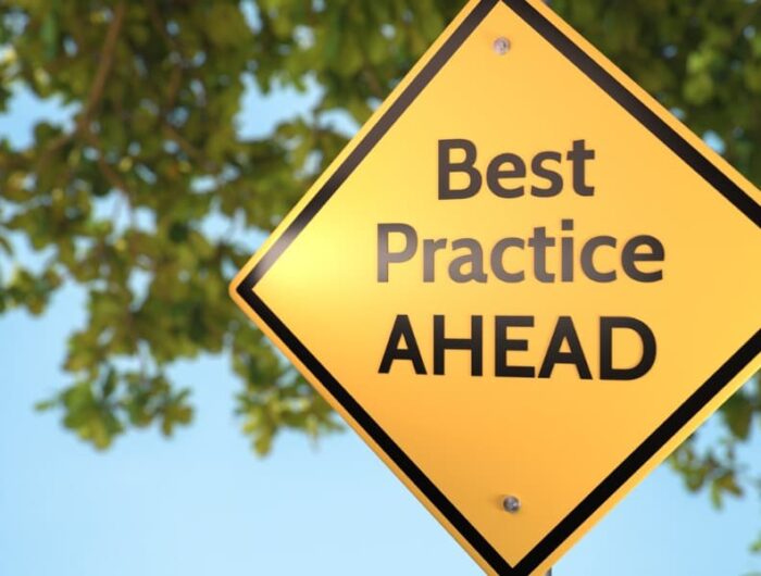 A yellow caution road sign with the words “best practice ahead” indicating the importance of keeping up with current trends and changes to have a thriving modern workplace.