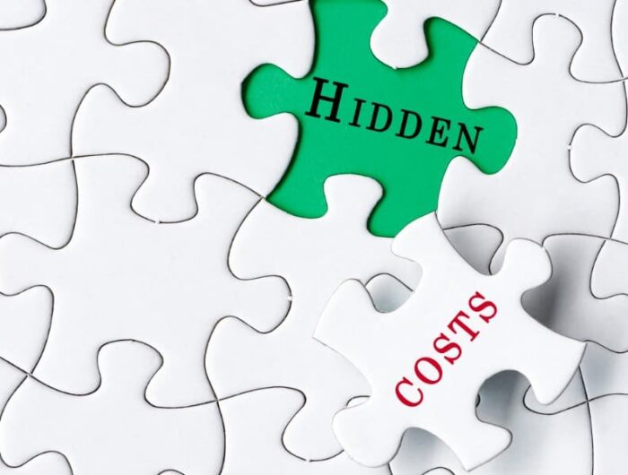 Puzzle pieces showing the words hidden costs on and under one piece.